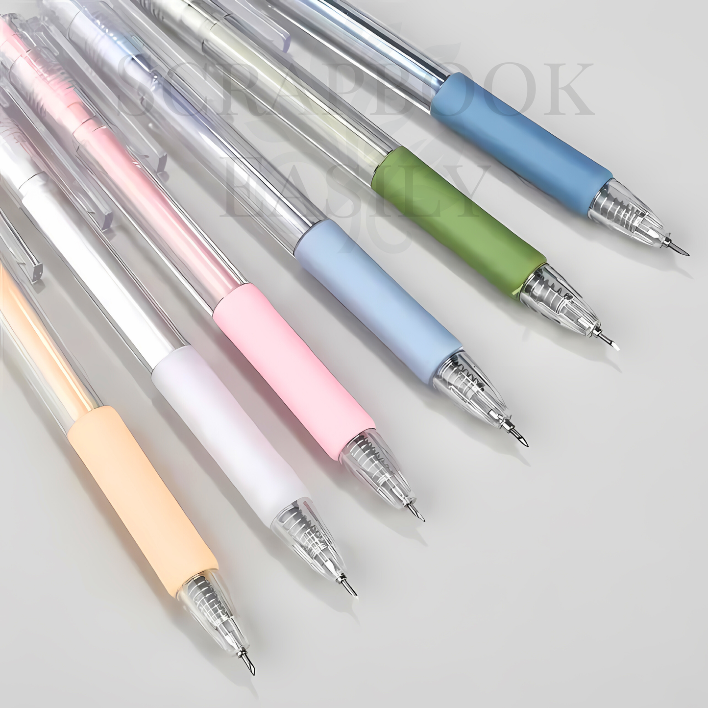 Assortment of precision craft knife pens laid out, featuring retractable blades & handles in soft colours including sage, blue, & pink, ideal for meticulous cutting in scrapbooking & other creative crafts, buy online.